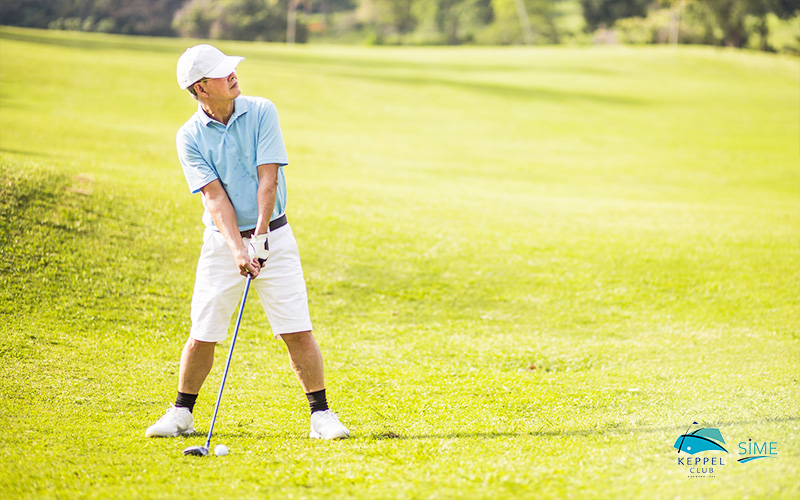 Senior Golfer on Putting Green About To Take The Shot