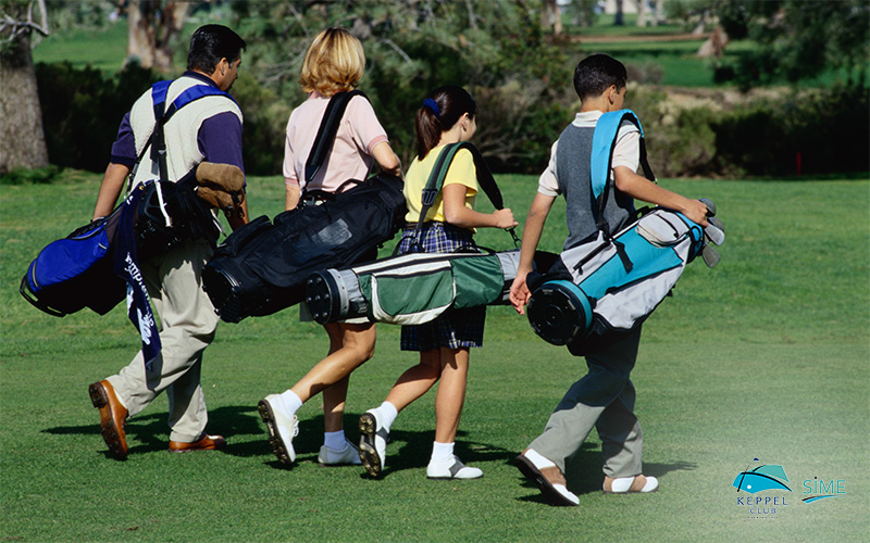 Golfers strolling on golf course with bags