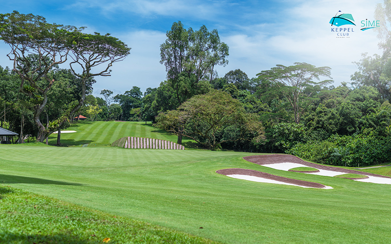 sunny driving range with distance markers at Keppel Club's public golf courses.