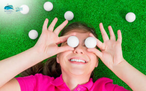 Young-girl-enjoying-golf-on-the-course-with-golf-balls