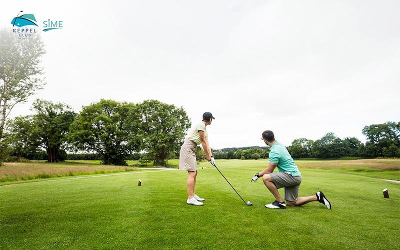 Keppel Club instructor guiding a golfer on the green